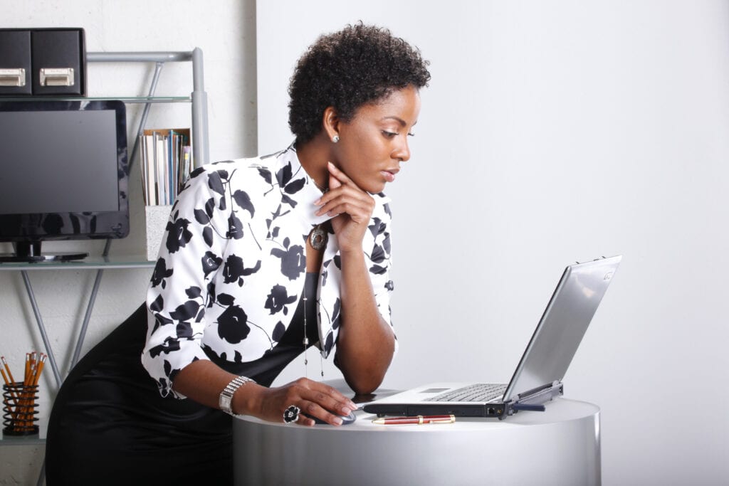 Cute executive interacts with her computer