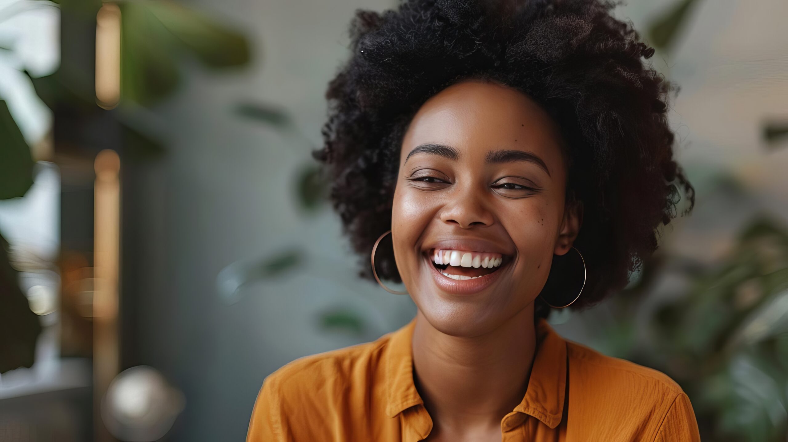 smiling african american woman working remotely laughing on virtual video call inclusive customer service